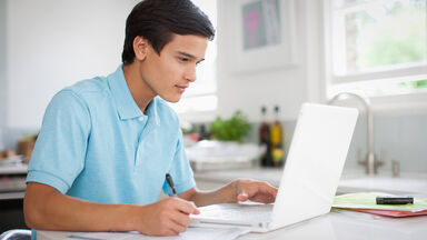 young man creating personal statement for application
