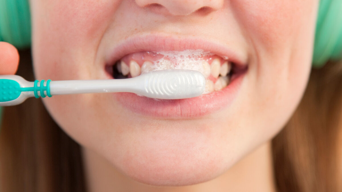 woman brushing her teeth