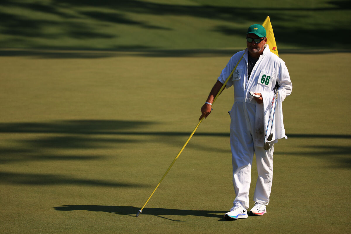 The traditional white Masters caddie uniform