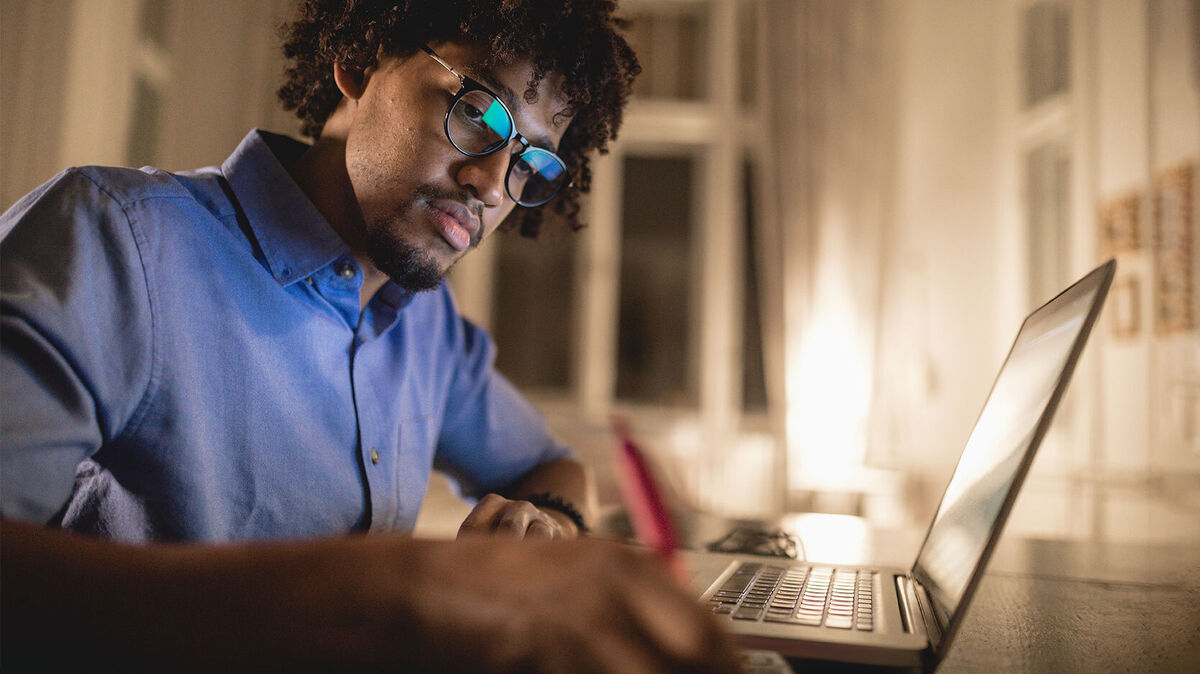 young man writing informative speech