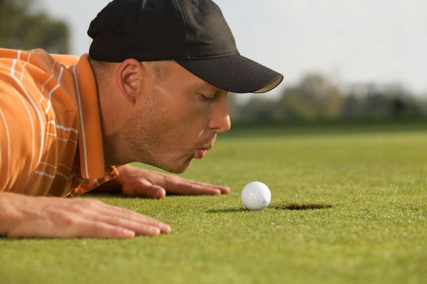 golf ball on edge of hole