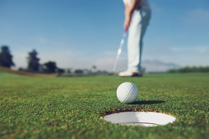 Golf Ball just before rolling into the hole