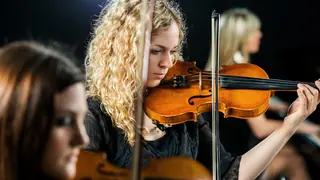 Woman playing violin classical music