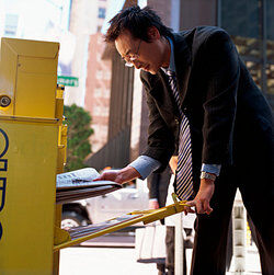 Man buying a newspaper as marginal utility examples