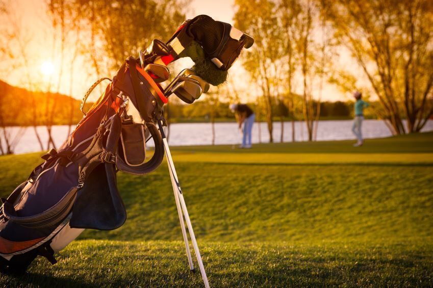 golf bag sits near green