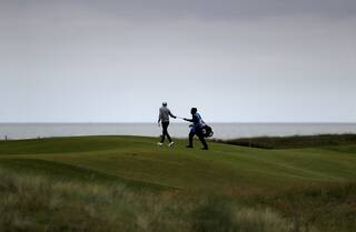 Golfer and caddie on the course