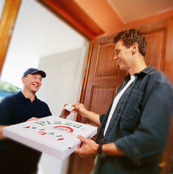 Man paying pizza delivery man as payment terms examples