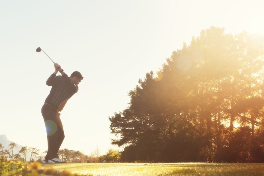 golfer in mid backswing.