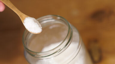 table salt in wooden spoon