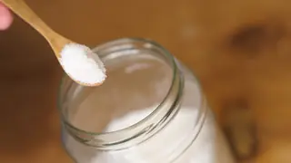 table salt in wooden spoon