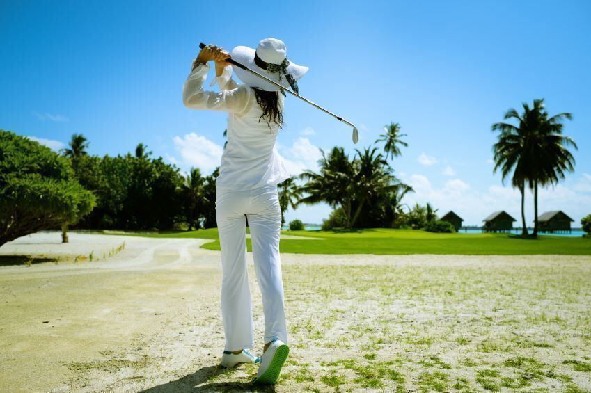 woman hits wedge shot