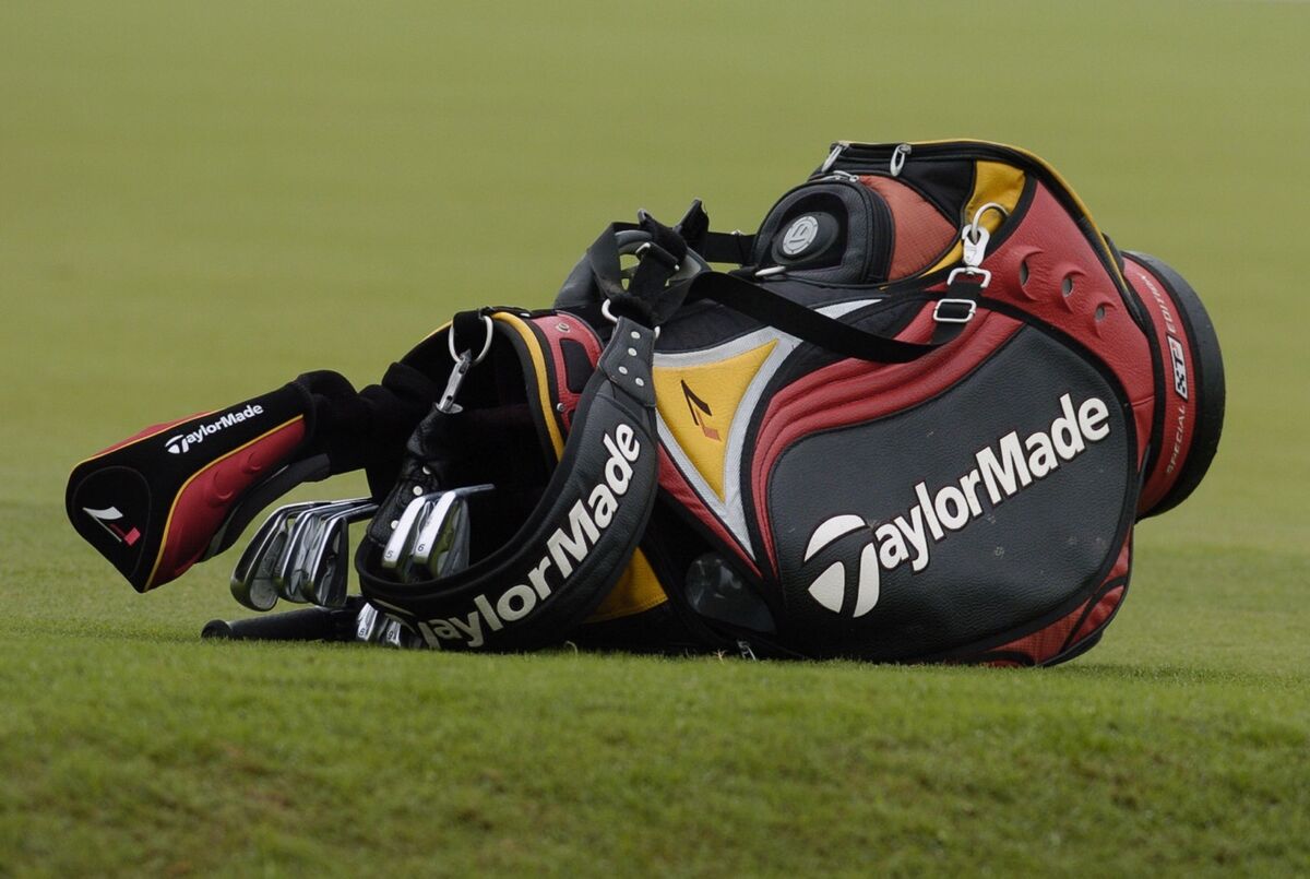 a taylormade golf bag rests on the ground