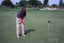 Golfer sinking a putt at 3 feet