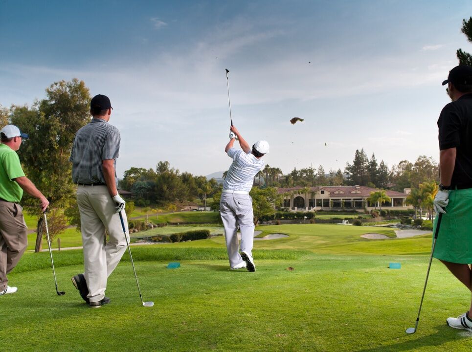 Four golfers teeing off