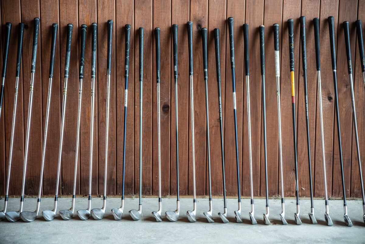 Golf clubs rest against a wall