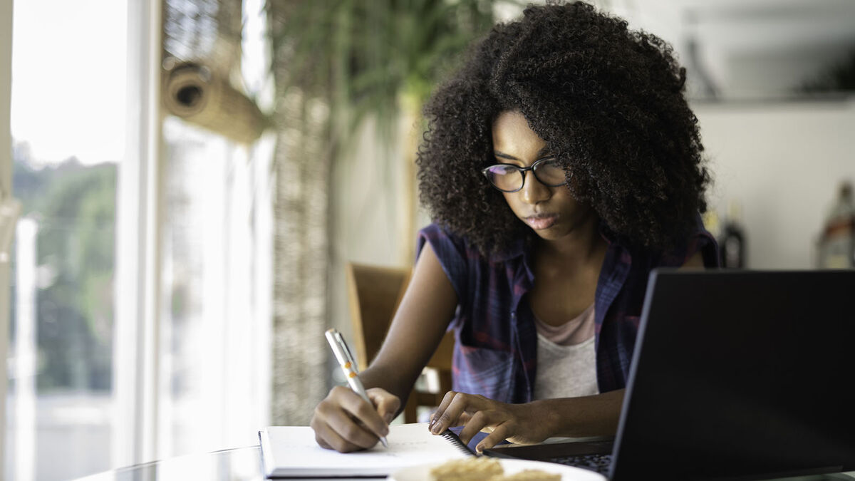 Stressed high school student writing essay