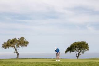 Golfer putts on Torrey Pines South Course