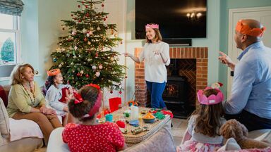 family playing Christmas charades game family playing Christmas charades game