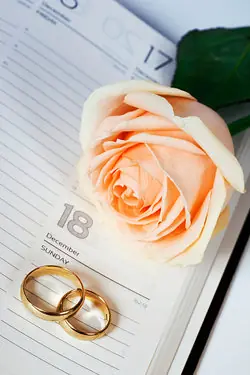 wedding rings and rose on diary page