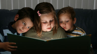 3 children reading a short story together