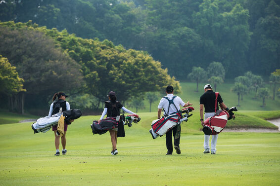 golfers walking with bags on course