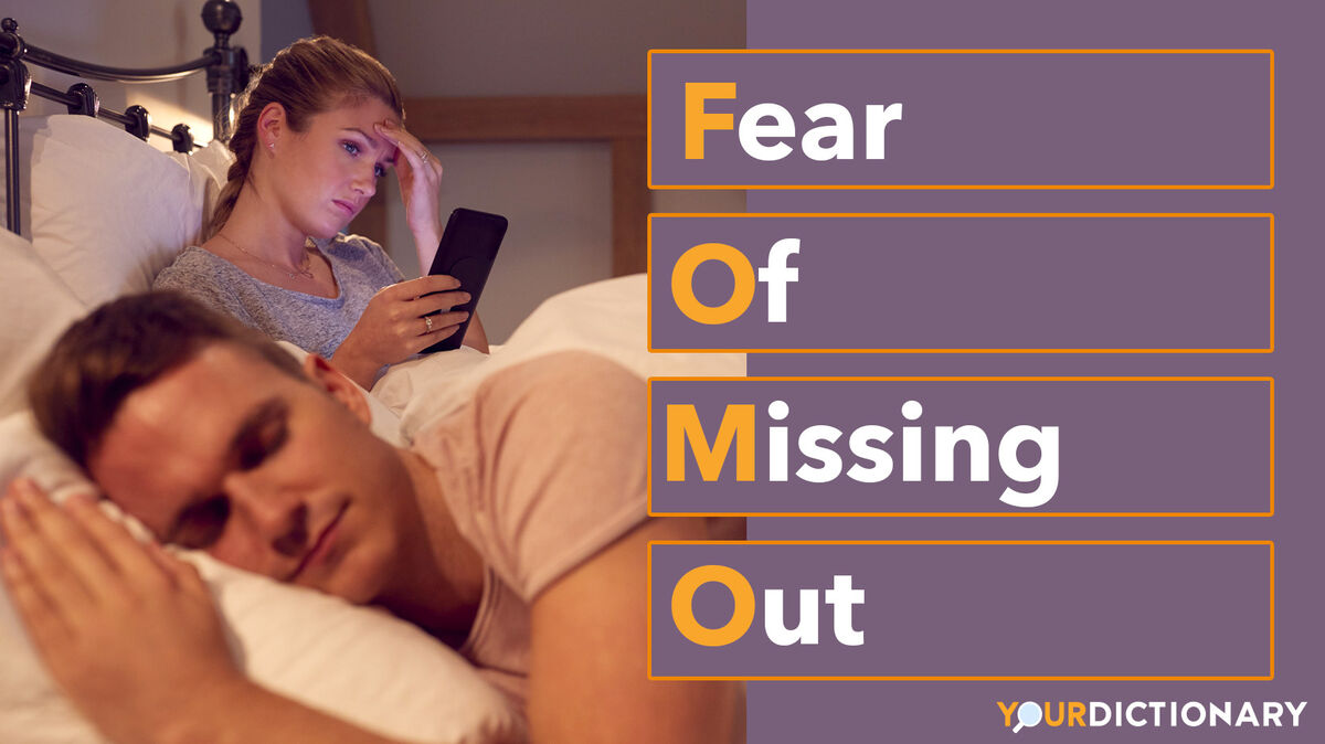 Woman Using Mobile Phone Man Sleeps FOMO Abbreviation Explained