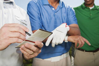 Golfers filling out handicap