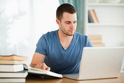 student working on bibliography on laptop
