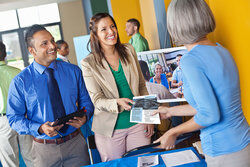 woman handing out corporate one pager