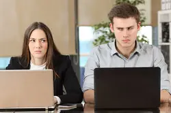 two angry co-workers at computer