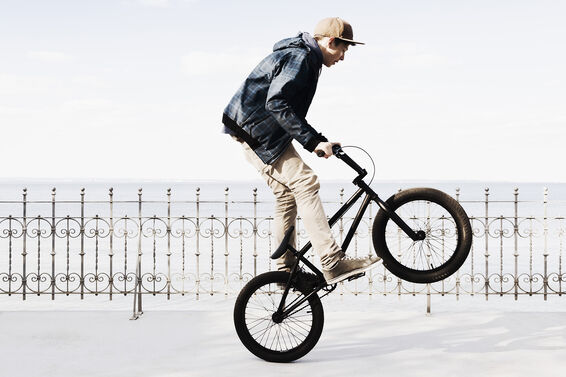 Boy riding BMX bicycle