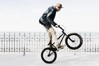 Boy riding BMX bicycle