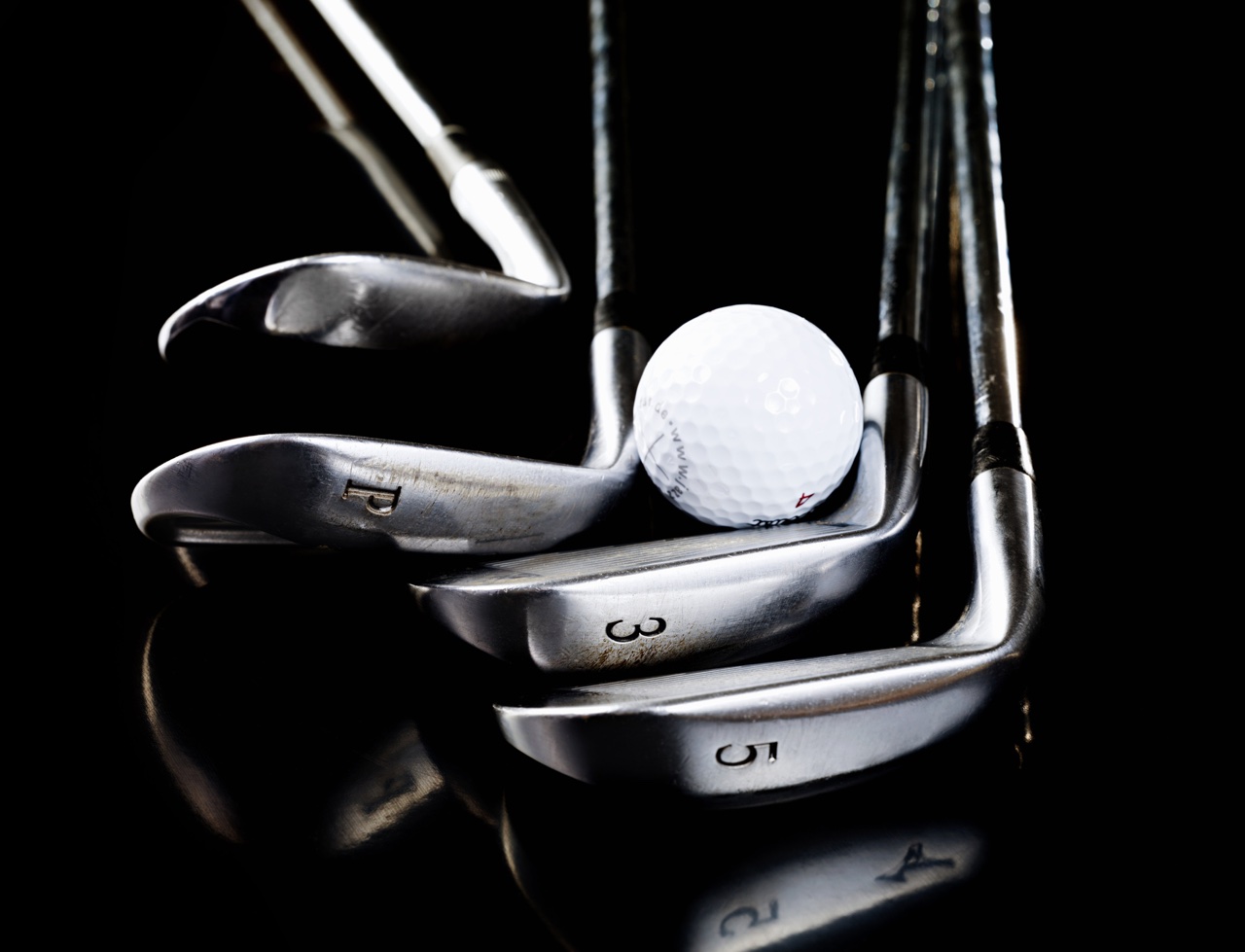 golf clubs and a golf ball golf clubs and a golf ball
