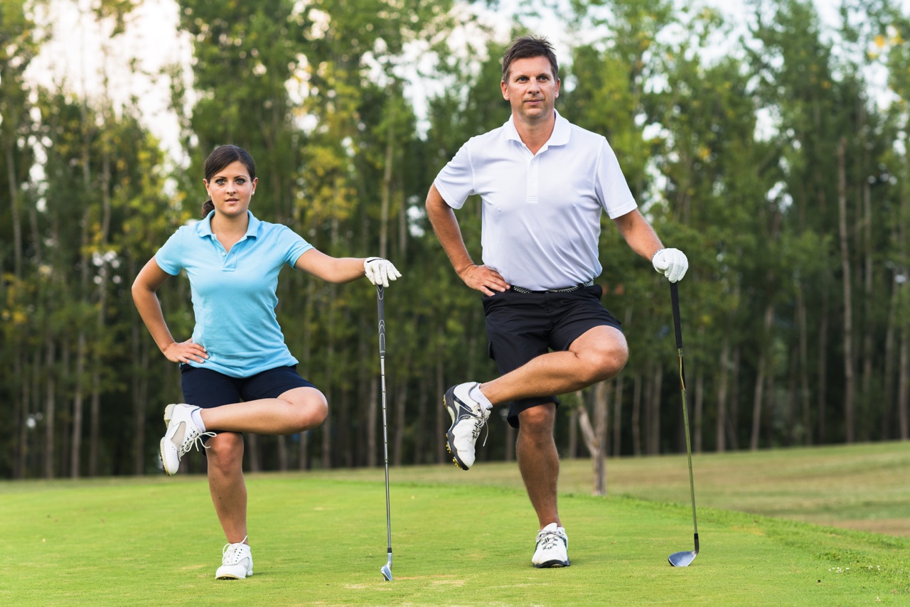 Two golfers stretch on the course