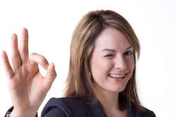 Businesswoman with a-okay hand gesture