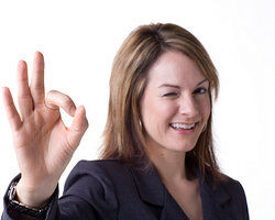 Businesswoman with a-okay hand gesture