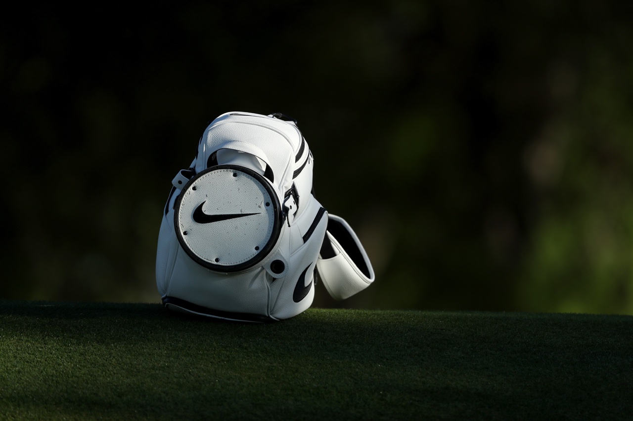 A Nike golf bag lays in the fairway