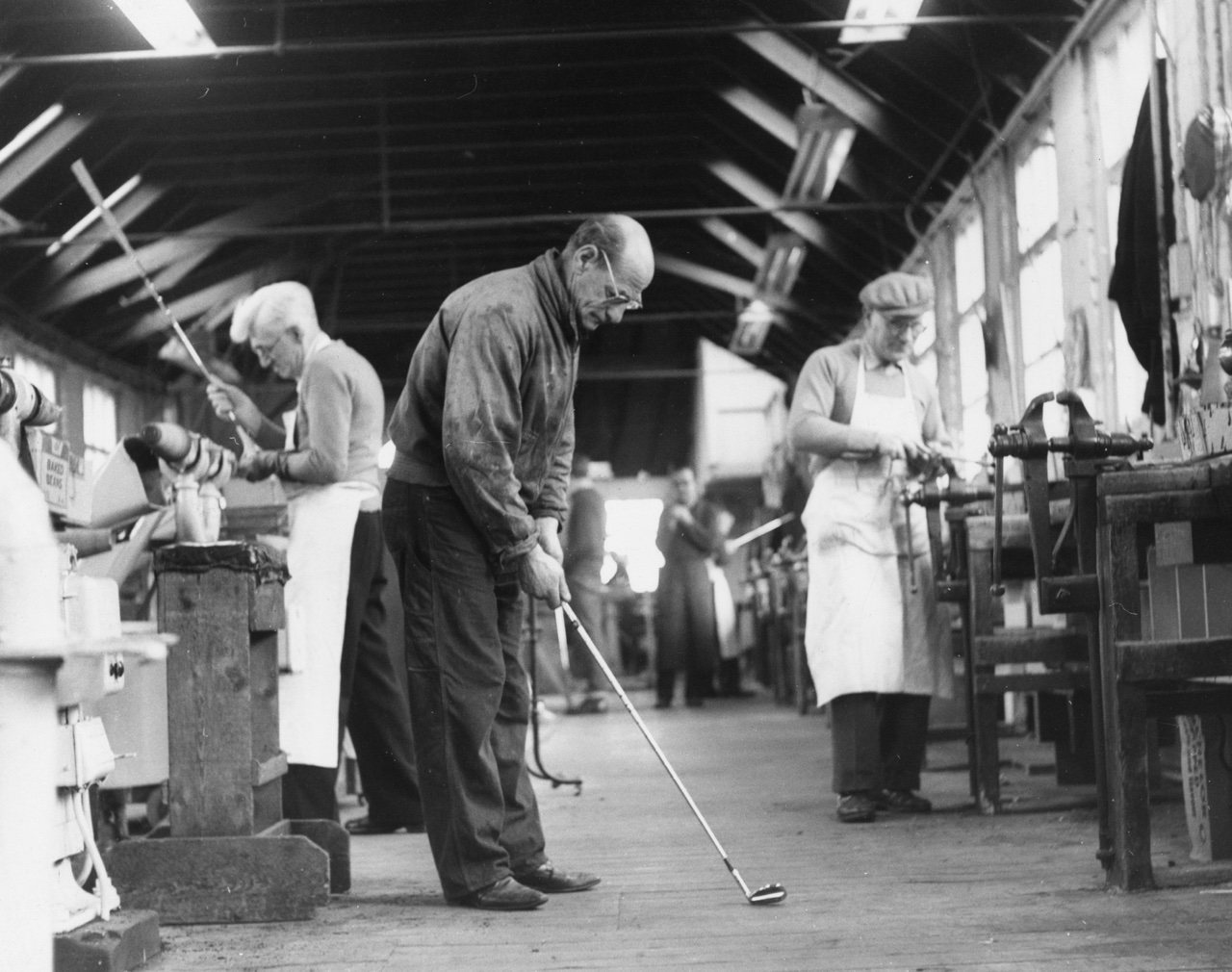 factory workers build spalding golf clubs
