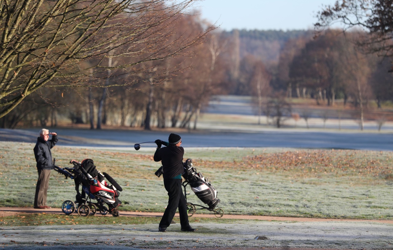 People playing golf in the winter