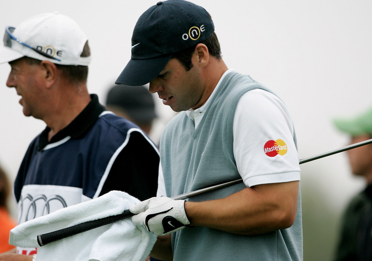 Pro golfer cleaning his golf grip Pro golfer cleaning his golf grip