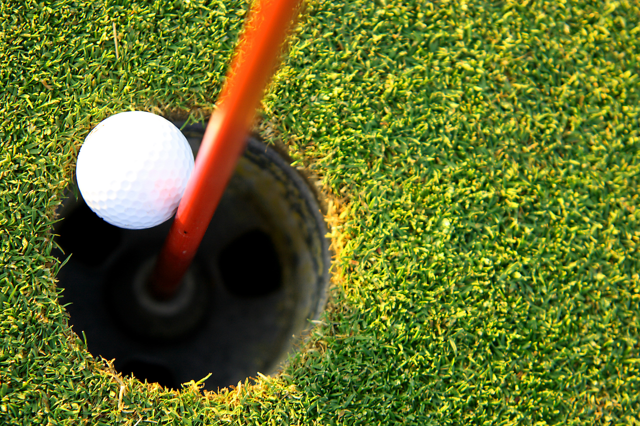 Golf ball stuck in hole