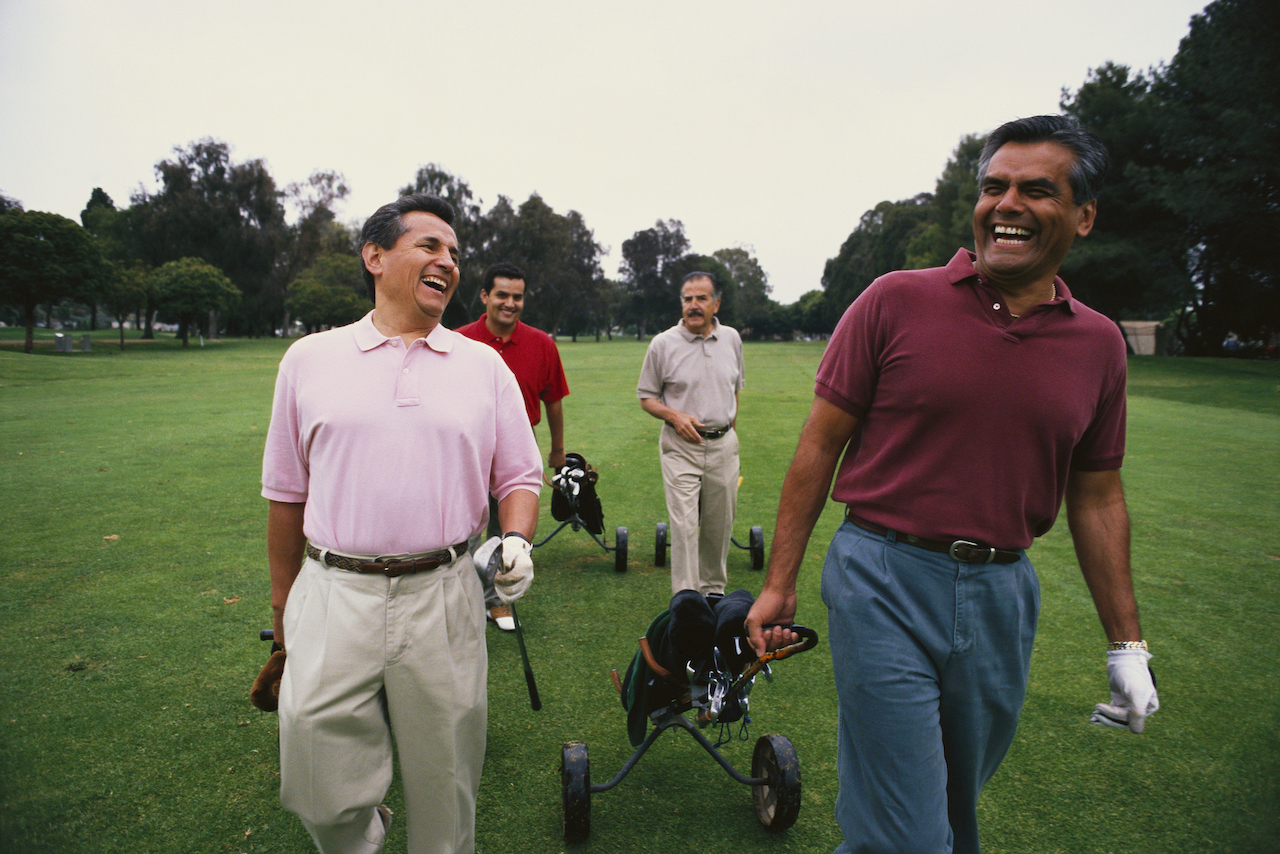 group of golfers walking on course