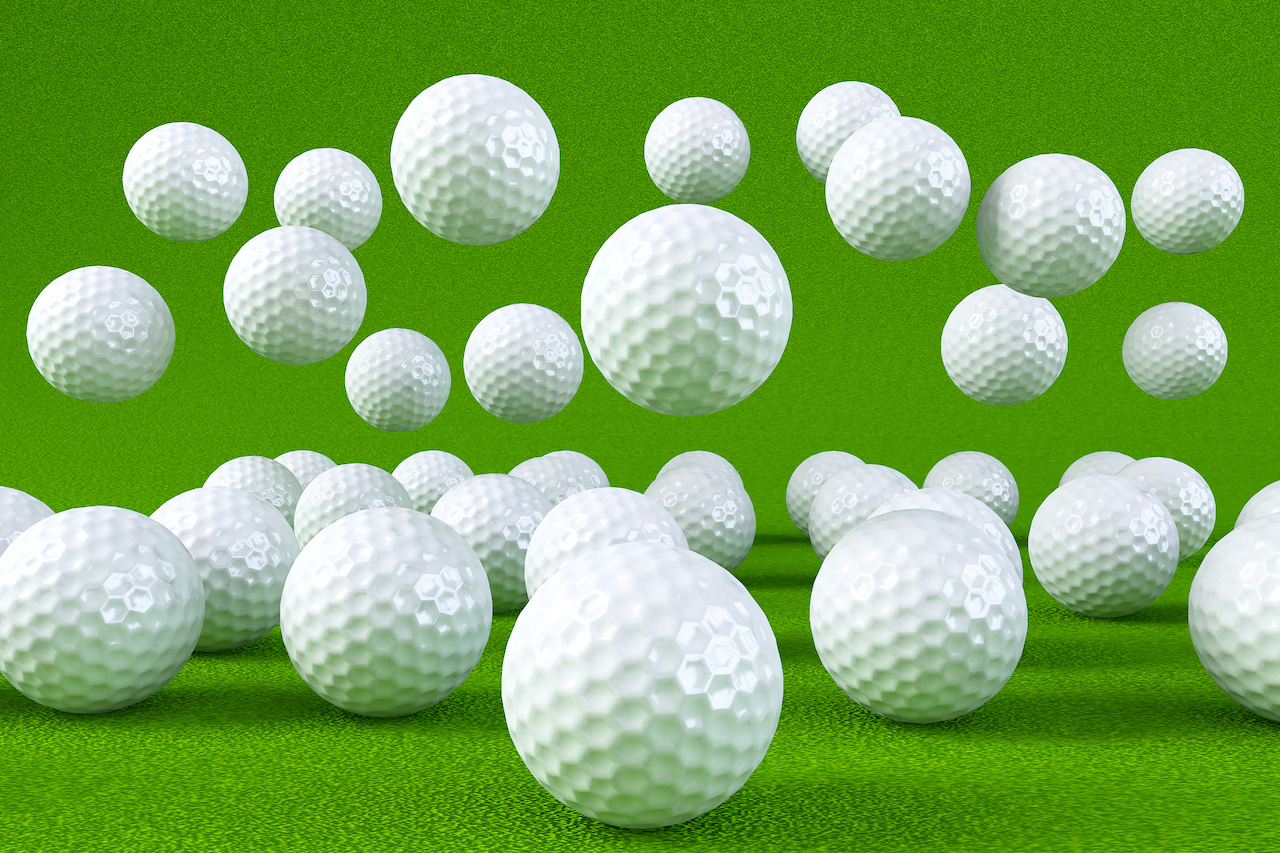 golf balls up close with green background
