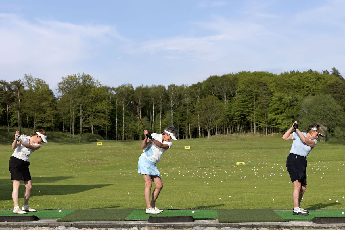 Three women at driving range