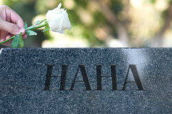 Putting rose on haha gravestone