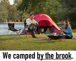 happy family camping by a river