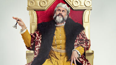 King sitting on a throne with a bell King sitting on a throne with a bell