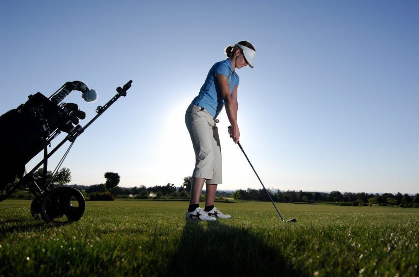 golfer swings on grass