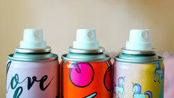 three aerosol cans