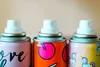 three aerosol cans